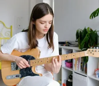 guitar-training-studio girl playing electric guitar